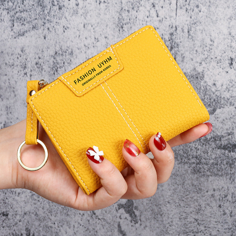 Petit portefeuille à coutures apparentes