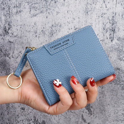 Petit portefeuille à coutures apparentes